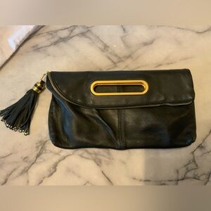 BCBGMaxAzria Black foldable Clutch ,tassel charm with Gold Details.